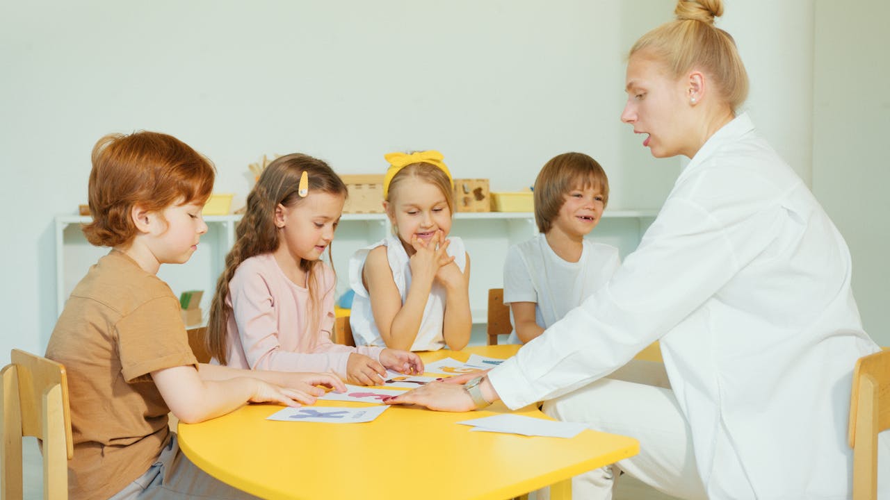 Educator supporting children in a learning activity